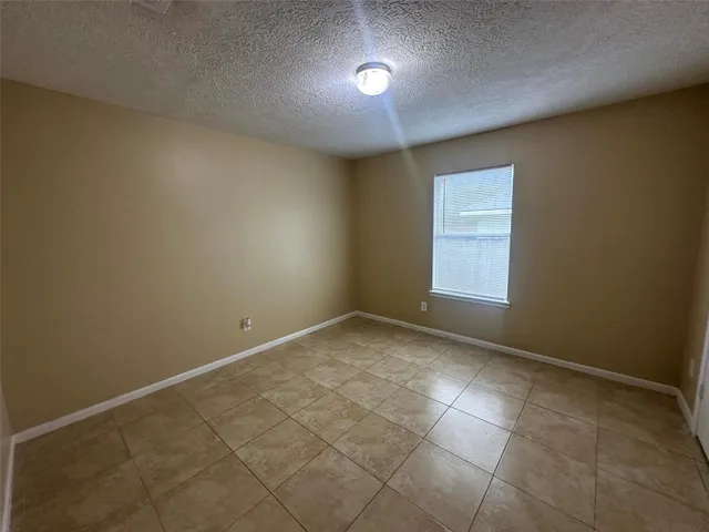 an empty room with a empty space and windows