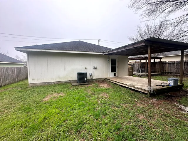 a backyard of a house with barbeque oven table and chairs