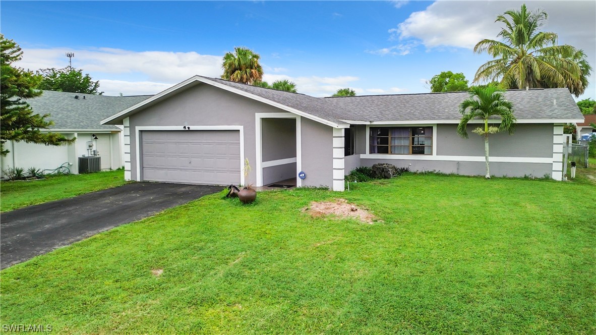 2437 42nd Terrace Southwest Naples, FL 34116 - Photo 1 of 34 a view of a house with a yard and potted plants