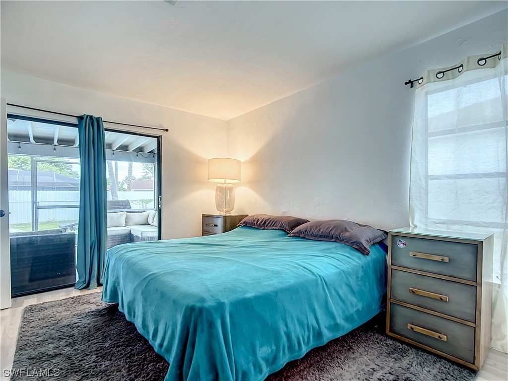 2437 42nd Terrace Southwest Naples, FL 34116 - Photo 19 of 34 a bedroom with a bed and a window