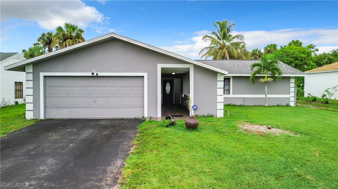 2437 42nd Terrace Southwest Naples, FL 34116 - Photo 2 of 34 a front view of house with yard