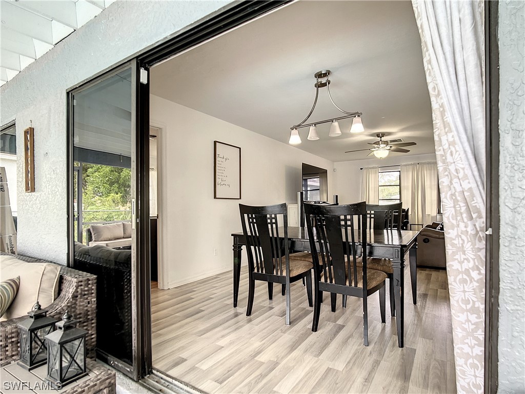 2437 42nd Terrace Southwest Naples, FL 34116 - Photo 26 of 34 a view of a dining room with furniture and wooden floor