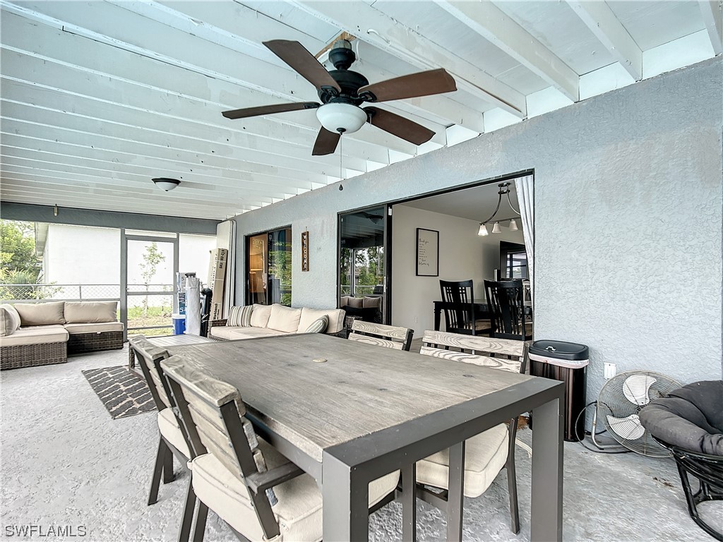 2437 42nd Terrace Southwest Naples, FL 34116 - Photo 28 of 34 a dining room with stainless steel appliances kitchen island granite countertop furniture and a large window