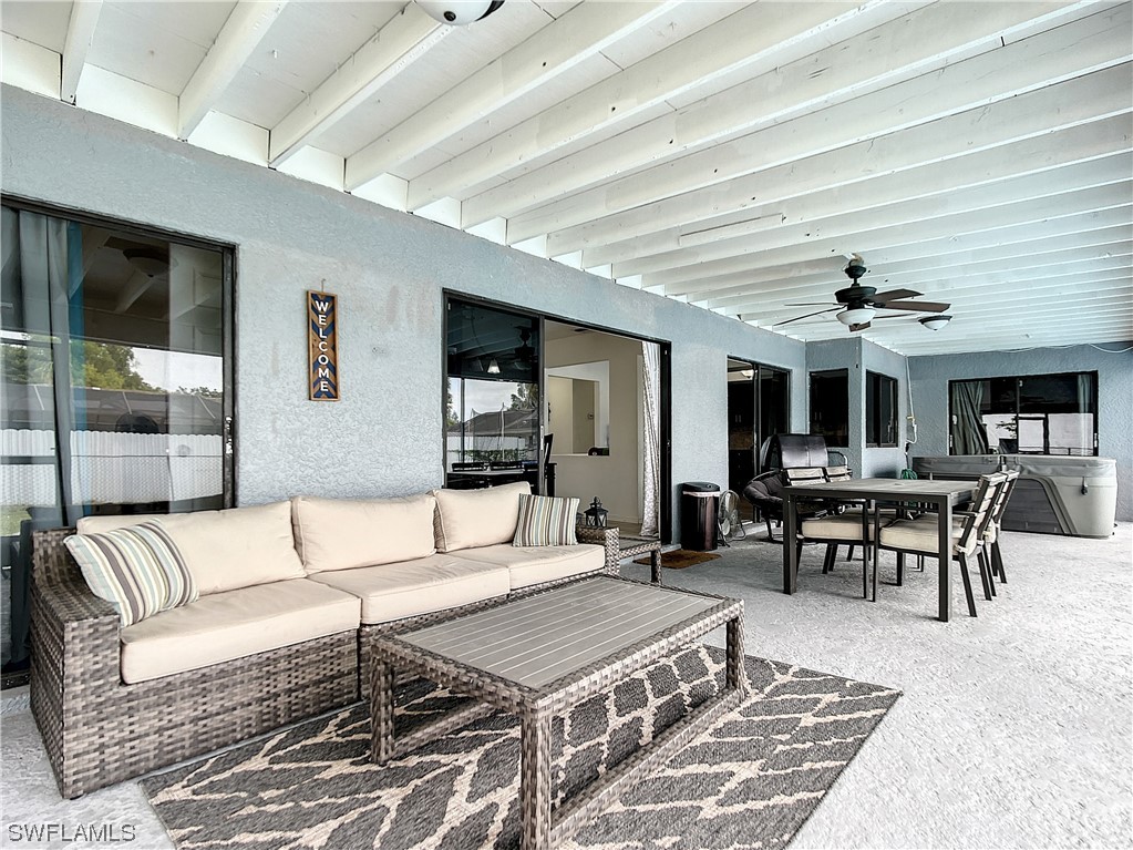 2437 42nd Terrace Southwest Naples, FL 34116 - Photo 29 of 34 a living room with furniture and a table