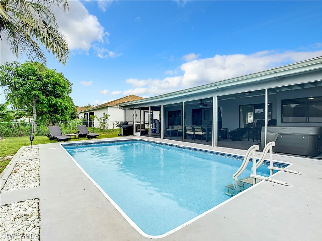 2437 42nd Terrace Southwest Naples, FL 34116 - Photo 32 of 34 a view of a house with swimming pool and sitting area