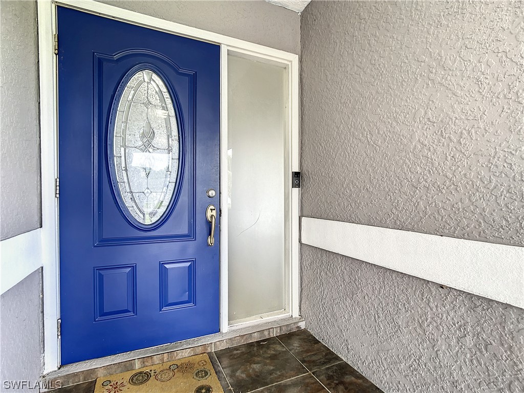 2437 42nd Terrace Southwest Naples, FL 34116 - Photo 4 of 34 a view of a wooden door with a wall