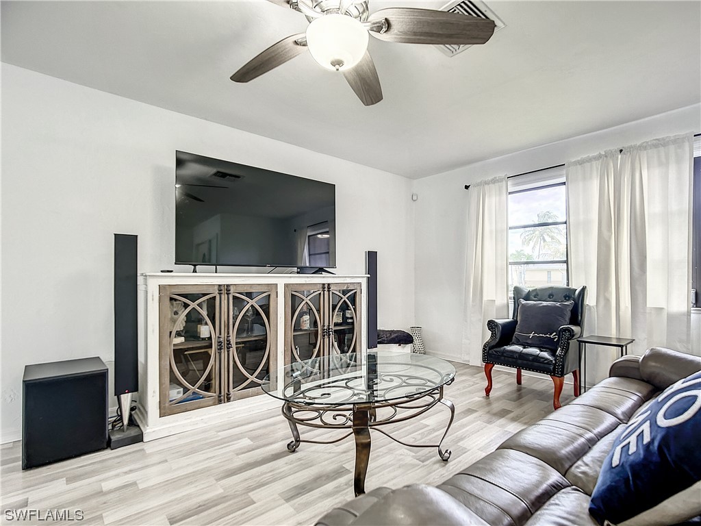 2437 42nd Terrace Southwest Naples, FL 34116 - Photo 5 of 34 a living room with furniture and a flat screen tv