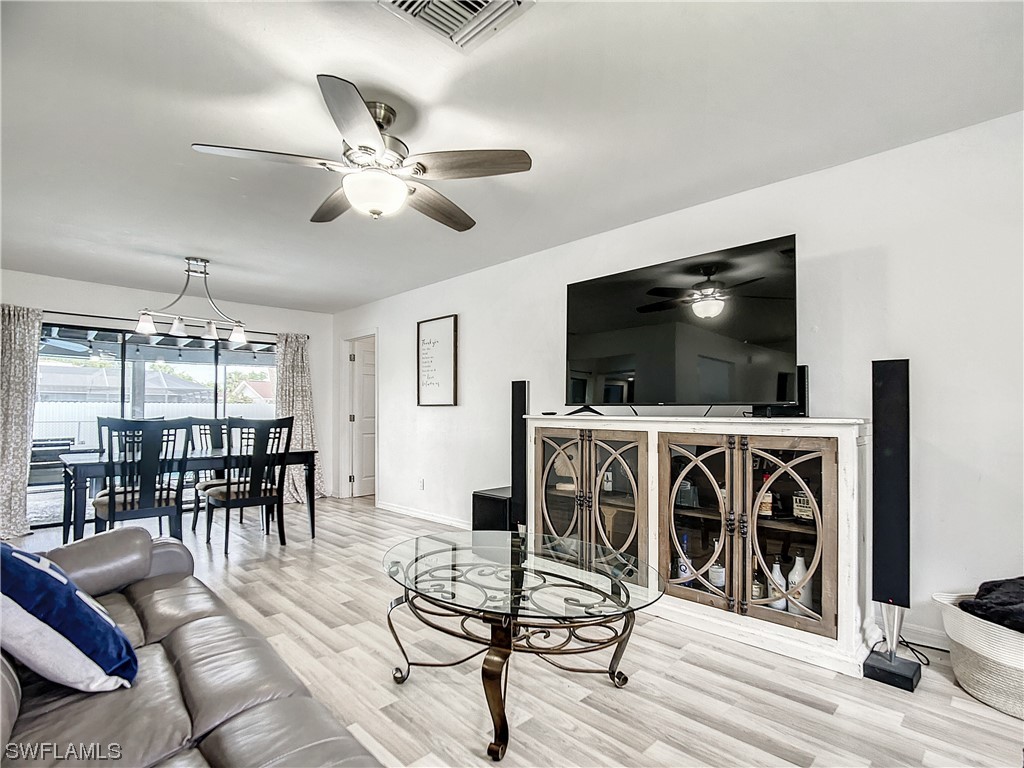 2437 42nd Terrace Southwest Naples, FL 34116 - Photo 6 of 34 a living room with furniture and a flat screen tv