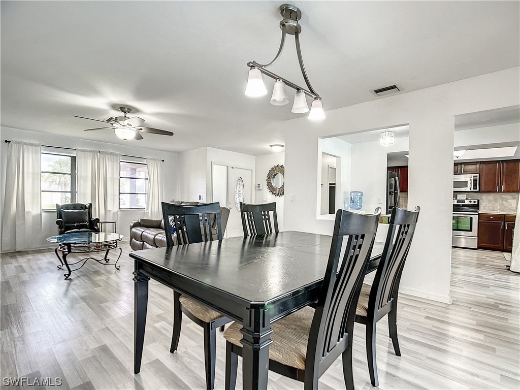 2437 42nd Terrace Southwest Naples, FL 34116 - Photo 9 of 34 a view of a dining room with furniture and wooden floor