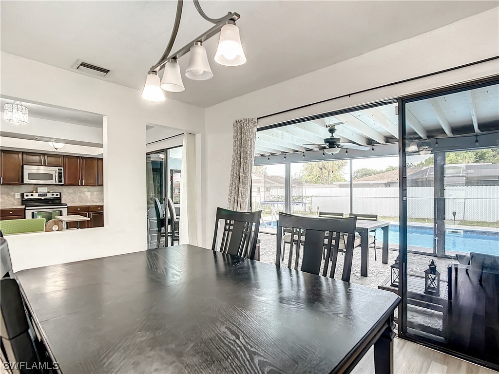 2437 42nd Terrace Southwest Naples, FL 34116 - Photo 10 of 34 a view of dining room and wooden floor