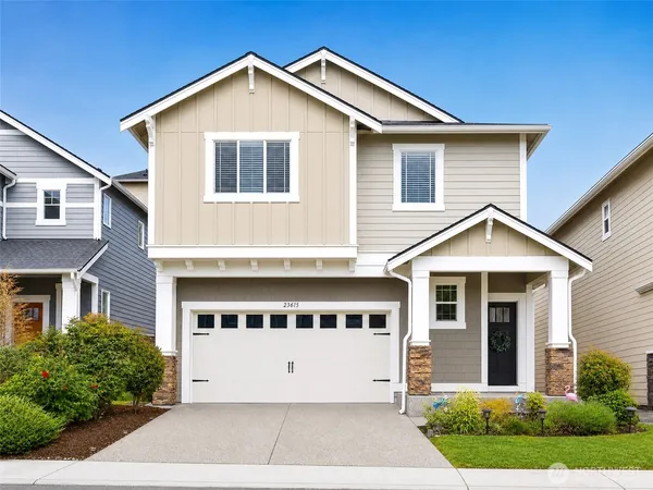 a front view of a house with a yard and garage