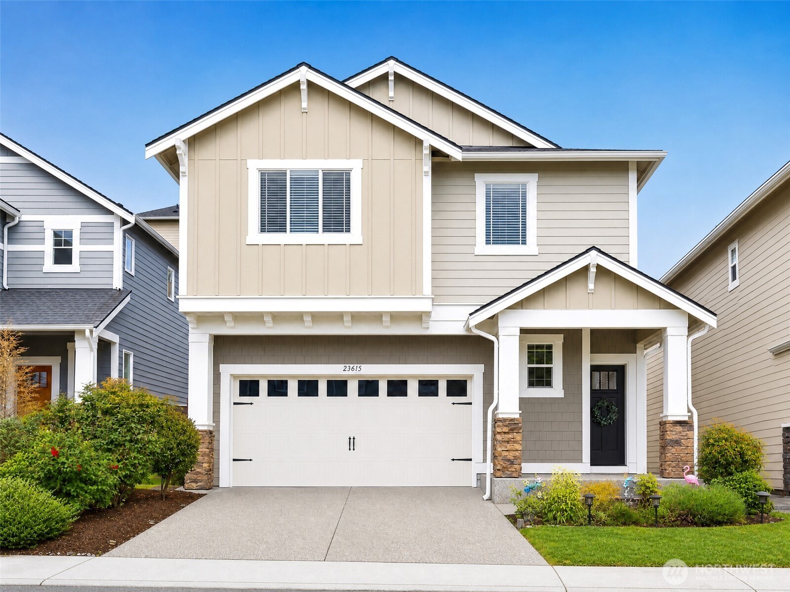 a front view of a house with a yard and garage