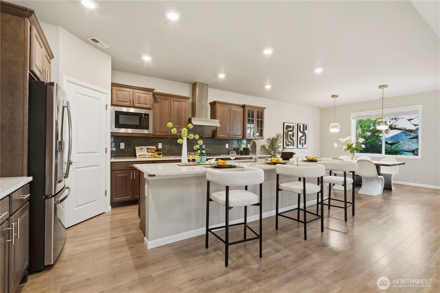 23615 43rd Drive Southeast Bothell, WA 98021 - Photo 11 of 35 a kitchen with kitchen island stainless steel appliances a table and chairs in it
