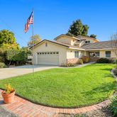 a view of a house with a backyard