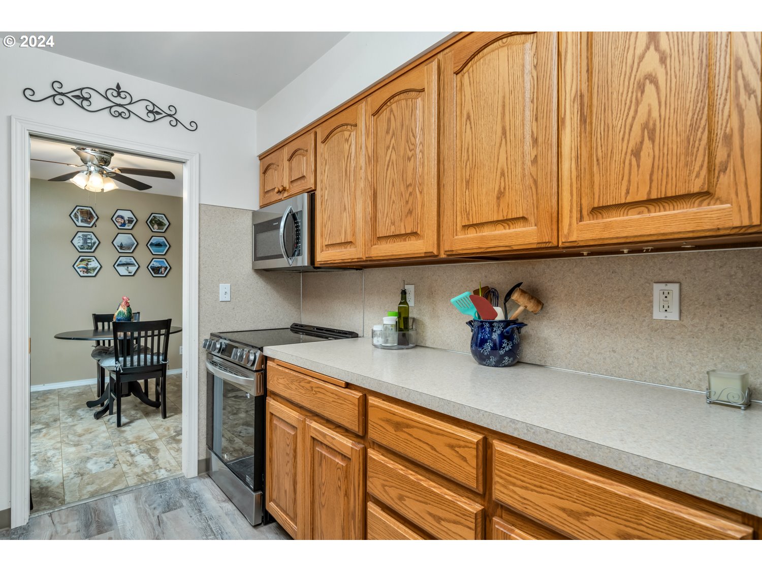 3217 Maple Street Longview, WA 98632 - Photo 13 of 32 a kitchen with stainless steel appliances granite countertop a sink dishwasher and cabinets with wooden floor