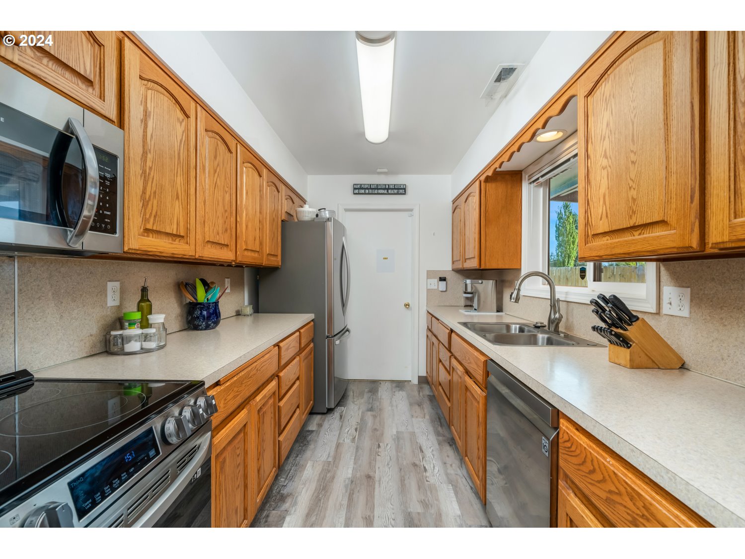 3217 Maple Street Longview, WA 98632 - Photo 14 of 32 a kitchen with a sink a stove and cabinets