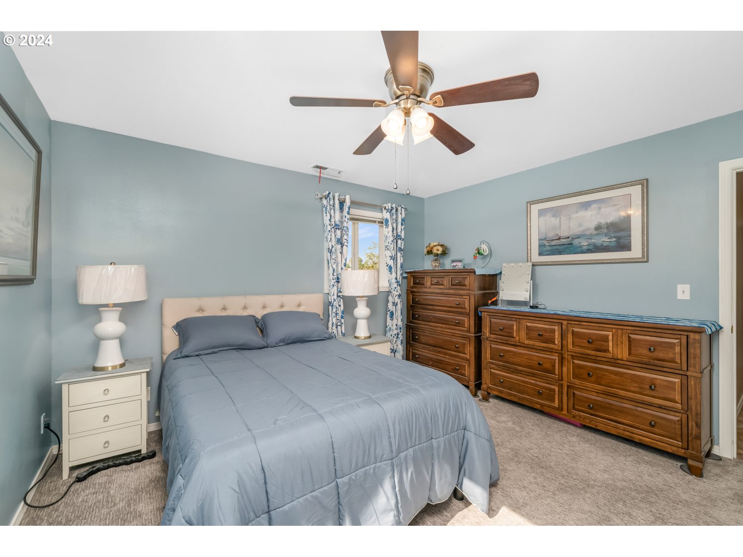 3217 Maple Street Longview, WA 98632 - Photo 17 of 32 a bedroom with a bed and a chandelier