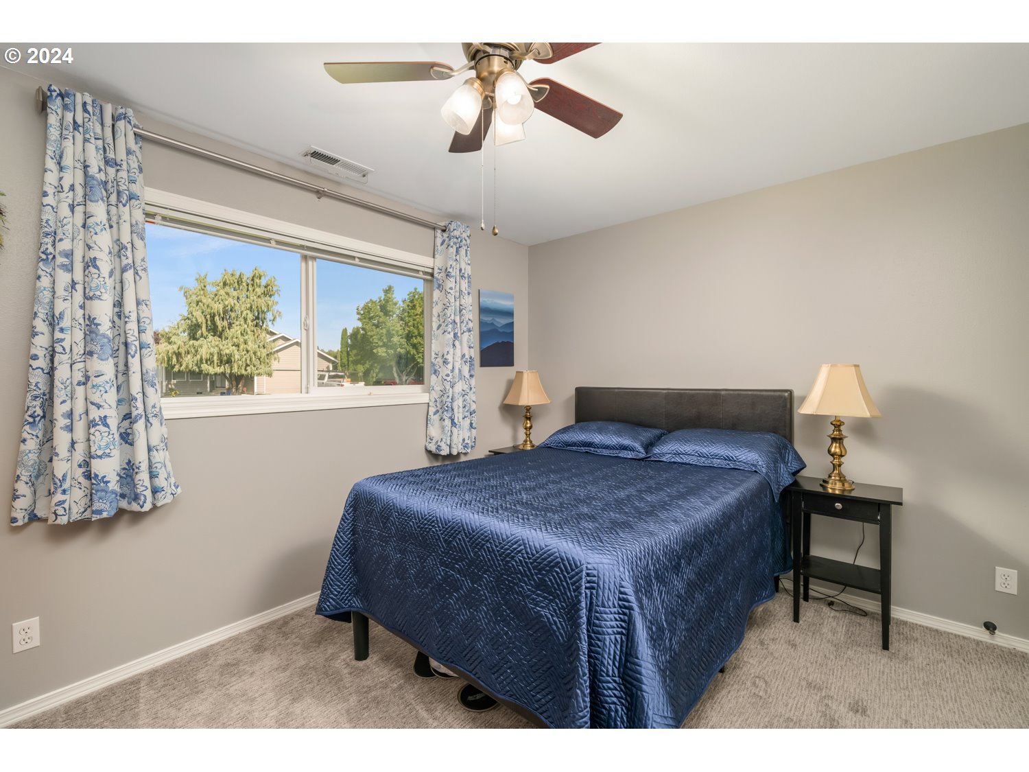 3217 Maple Street Longview, WA 98632 - Photo 24 of 32 a bedroom with a bed and a chandelier