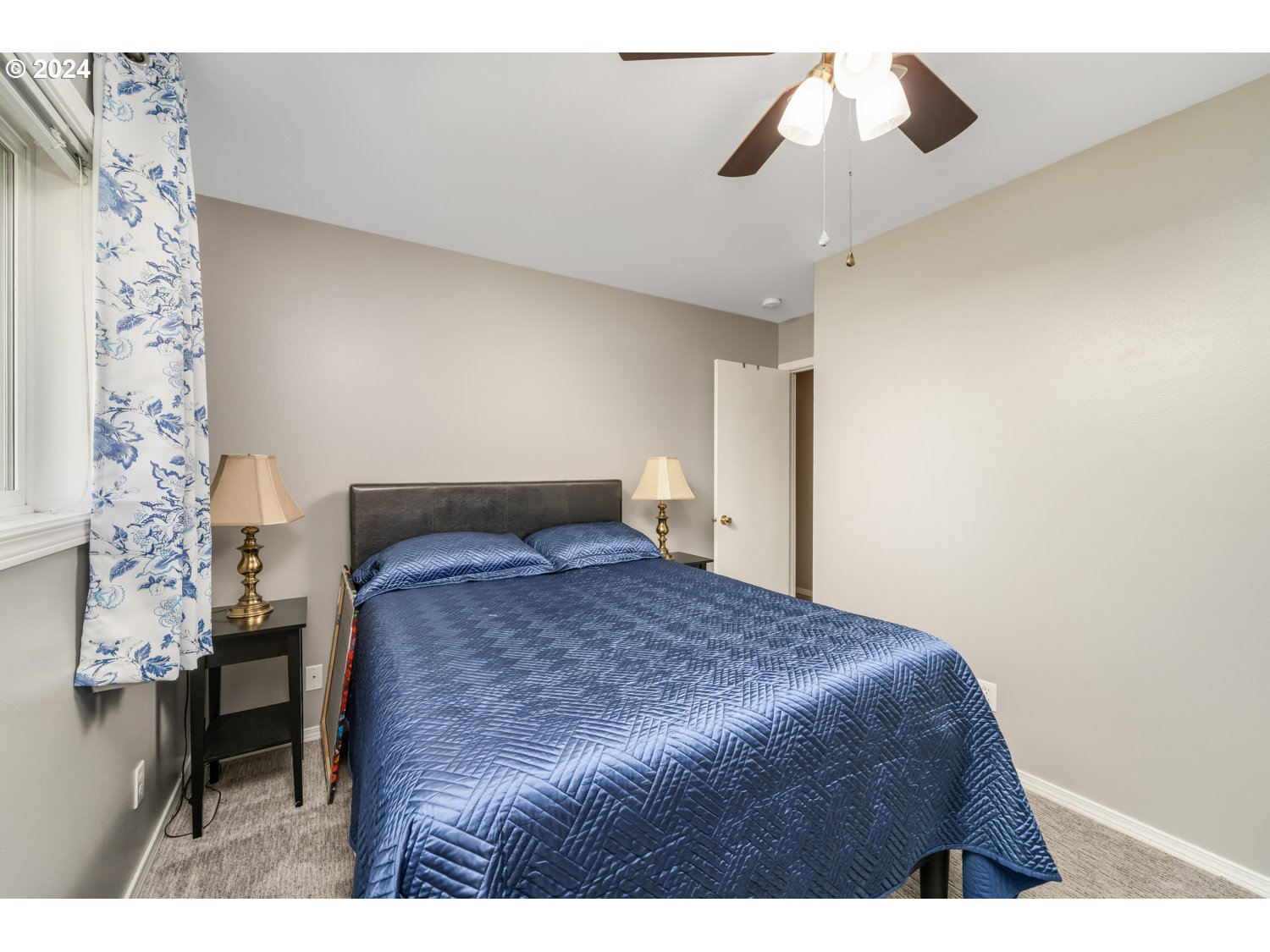 3217 Maple Street Longview, WA 98632 - Photo 25 of 32 a bedroom with a bed and a chandelier