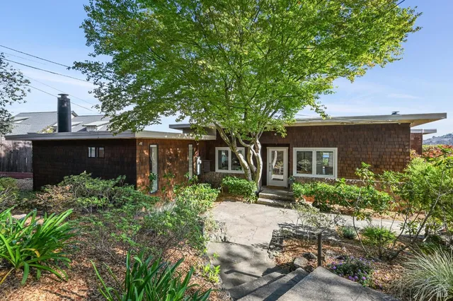 a front view of a house with garden