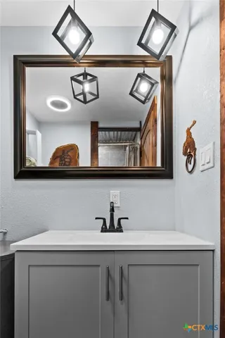 a bathroom with a sink and a mirror