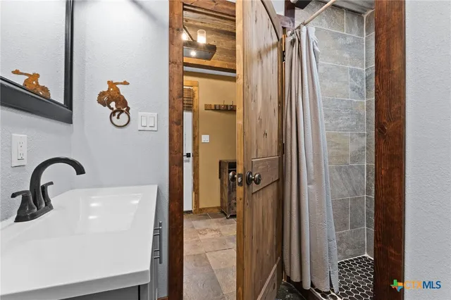 a bathroom with a shower and mirror