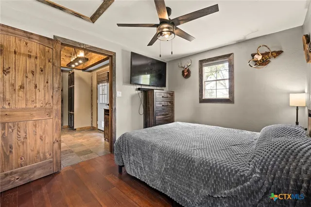 a spacious bedroom with a bed and a chandelier
