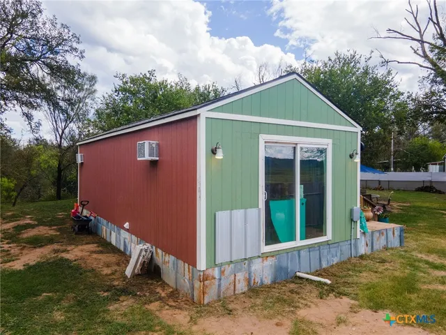 a living room with furniture cabinets and a flat screen tv