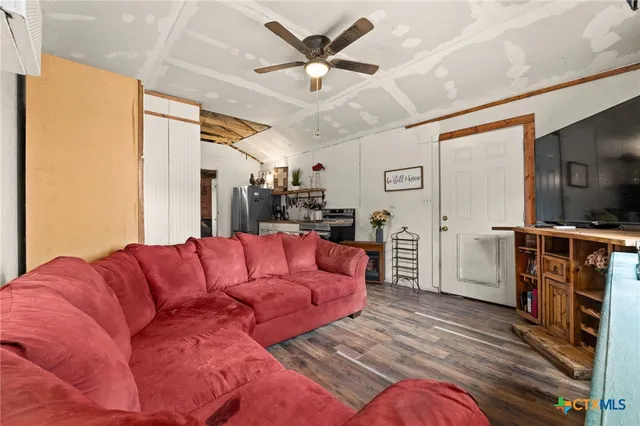 a kitchen with refrigerator and cabinets