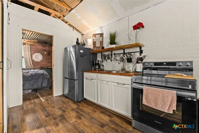 a kitchen with stainless steel appliances granite countertop a stove and a refrigerator