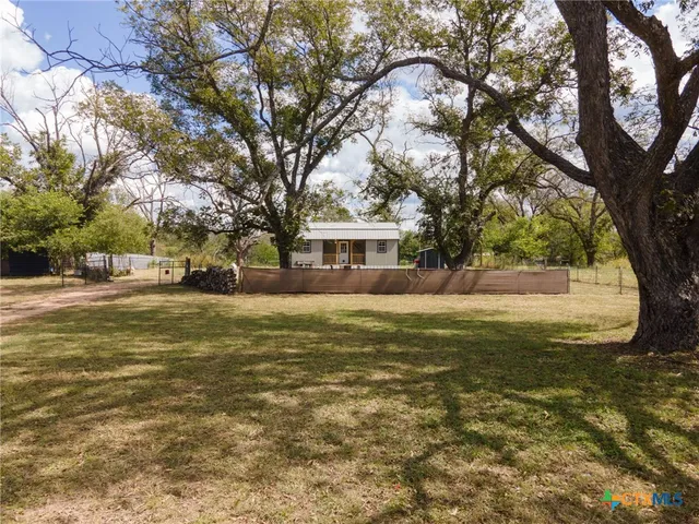 a view of road with large trees