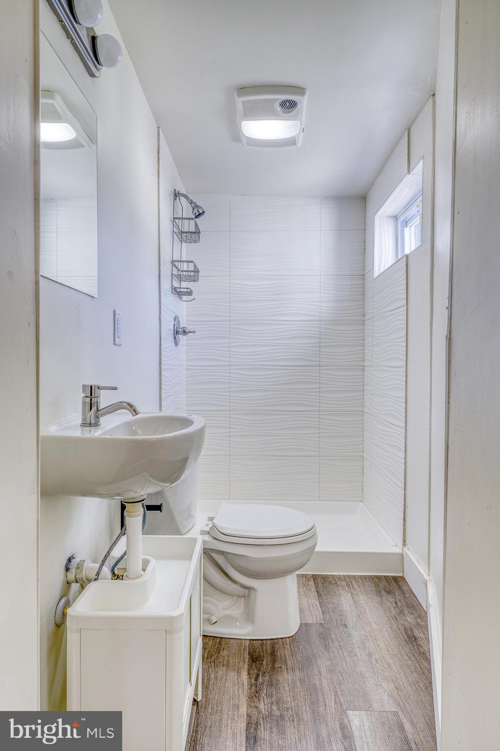 7104 Harford Road Baltimore, MD 21234 - Photo 34 of 37 a bathroom with a sink toilet and a mirror