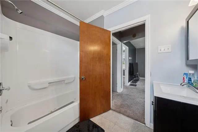 a bathroom with a tub and a sink