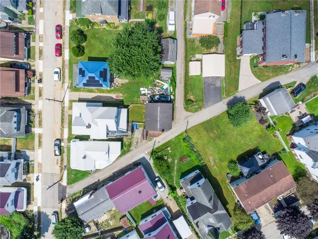 an aerial view of houses with outdoor space
