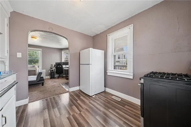a view of a livingroom with furniture and an empty room