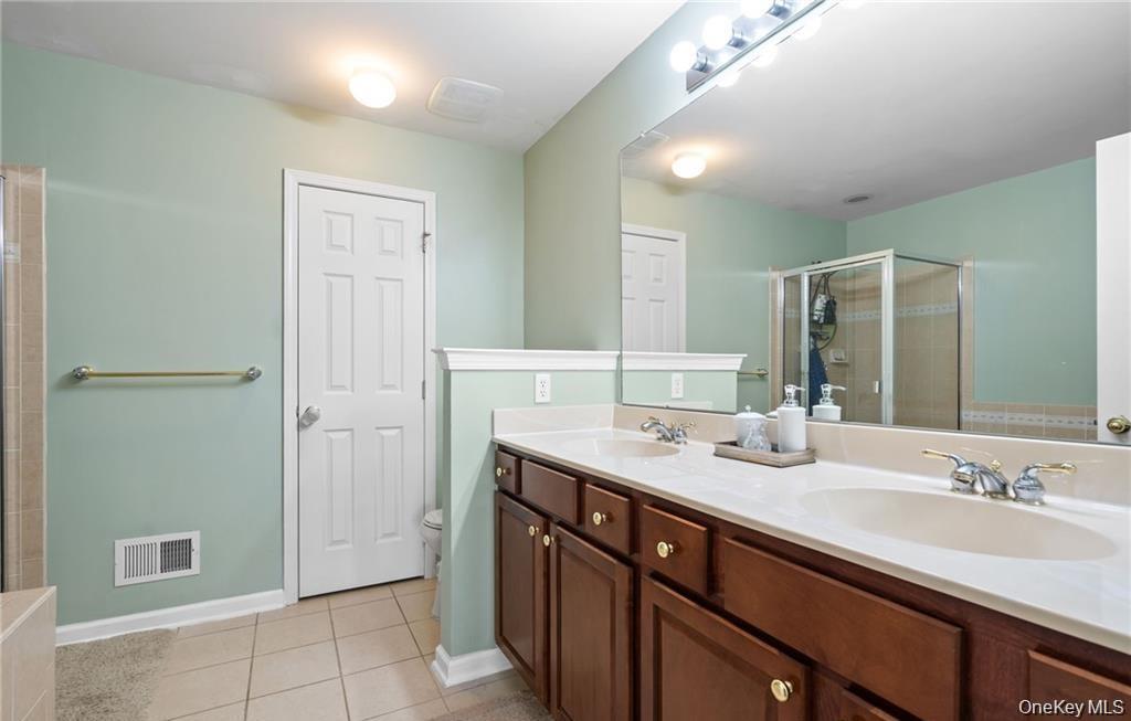 5 Case Court Monroe, NY 10950 - Photo 15 of 35 a bathroom with a granite countertop sink and a mirror