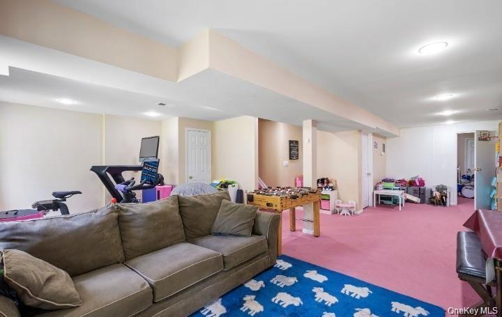 5 Case Court Monroe, NY 10950 - Photo 21 of 35 a living room with furniture and a gym with kitchen countertops