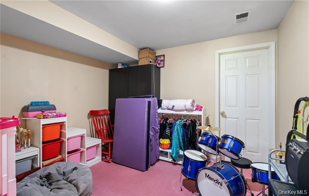 5 Case Court Monroe, NY 10950 - Photo 23 of 35 a living room with furniture a rug and a closet