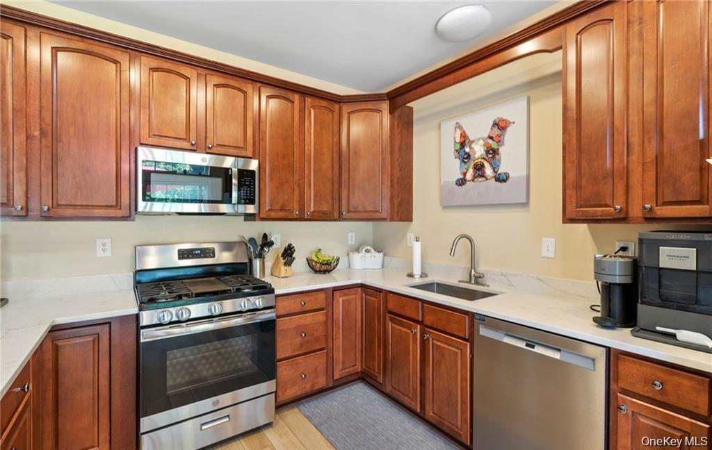 5 Case Court Monroe, NY 10950 - Photo 10 of 35 a kitchen with stainless steel appliances granite countertop a stove a sink dishwasher and a microwave
