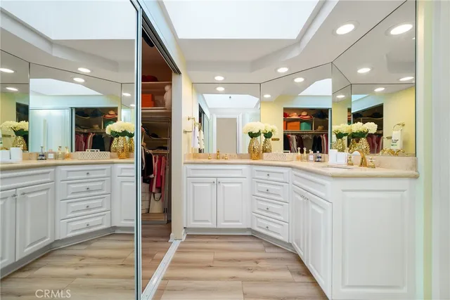 a kitchen with kitchen island granite countertop a sink and cabinets