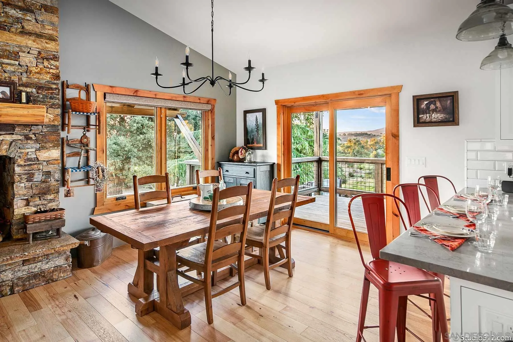3208 Eagle Peak Road Julian, CA 92036 - Photo 27 of 65 a view of a dining room with furniture large windows and wooden floor