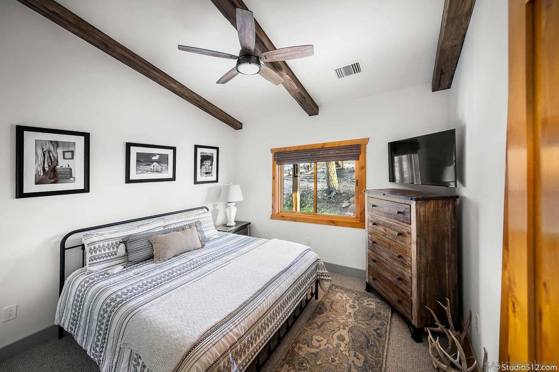 3208 Eagle Peak Road Julian, CA 92036 - Photo 42 of 65 a bedroom with a bed window and a flat screen tv