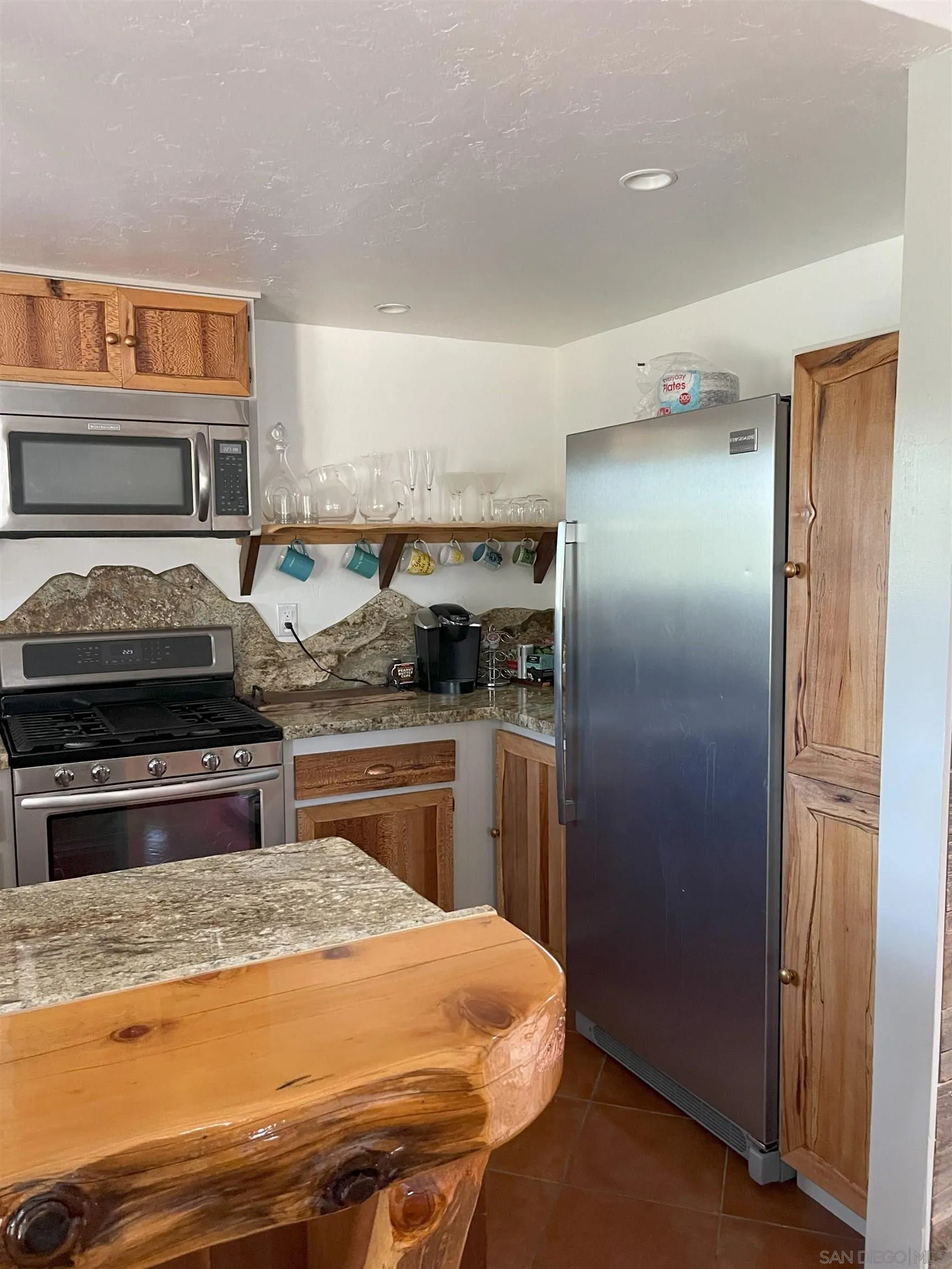 3208 Eagle Peak Road Julian, CA 92036 - Photo 52 of 65 a kitchen with stainless steel appliances granite countertop a refrigerator and a stove