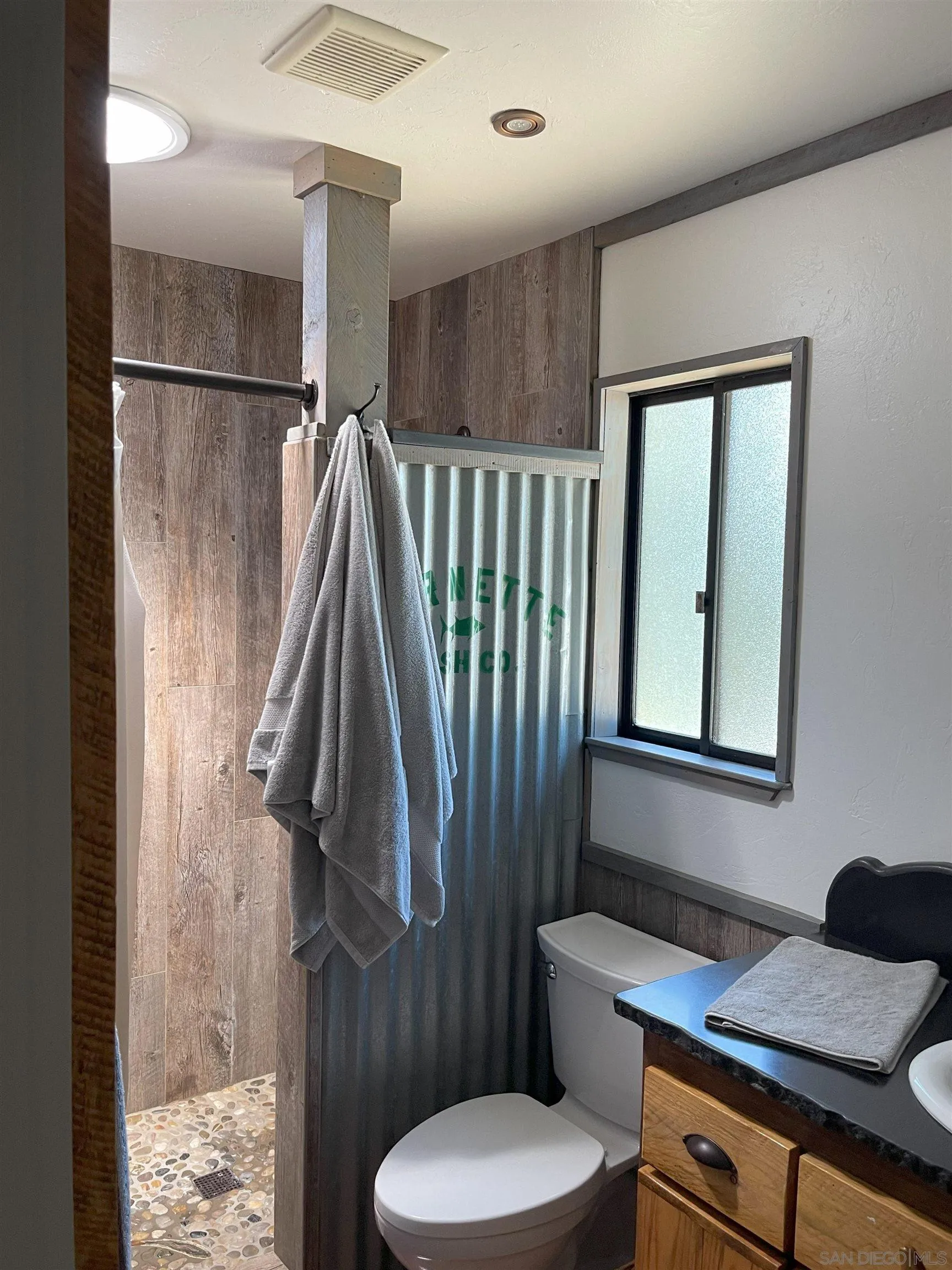 3208 Eagle Peak Road Julian, CA 92036 - Photo 61 of 65 a bathroom with a granite countertop sink toilet and shower