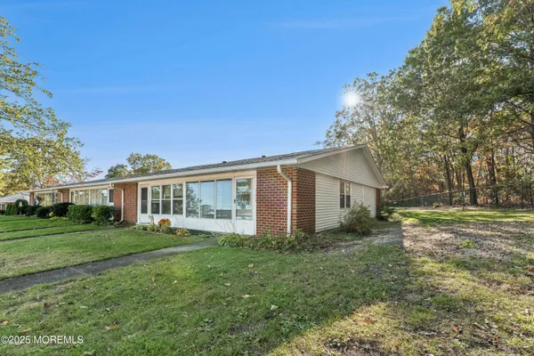 a front view of house with yard and green space