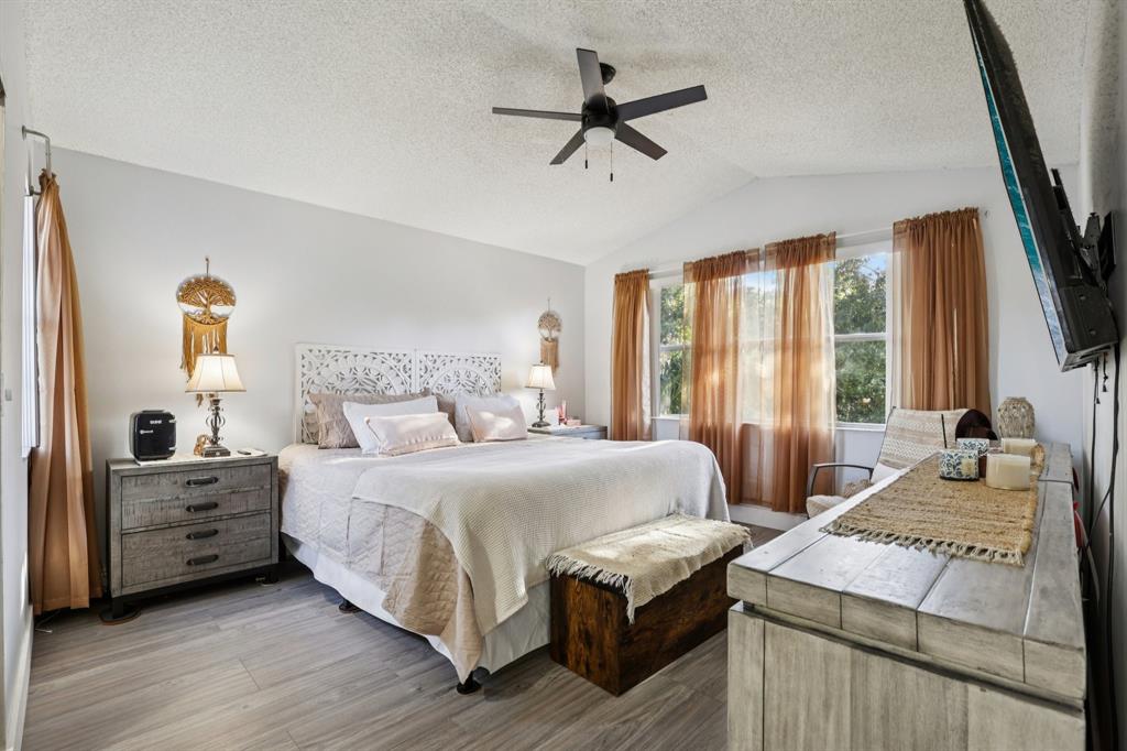 972 Azure Lane Weston, FL 33326 - Photo 11 of 61 a bedroom with a bed a large window and flat screen tv