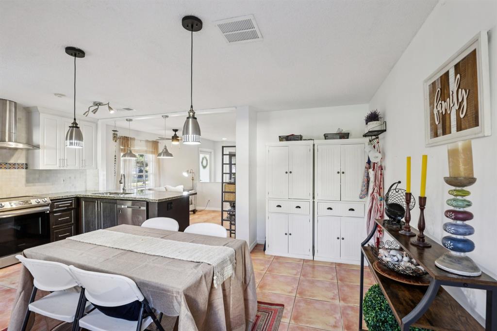 972 Azure Lane Weston, FL 33326 - Photo 18 of 61 a kitchen with stainless steel appliances kitchen island granite countertop a stove a sink dishwasher and white cabinets with wooden floor