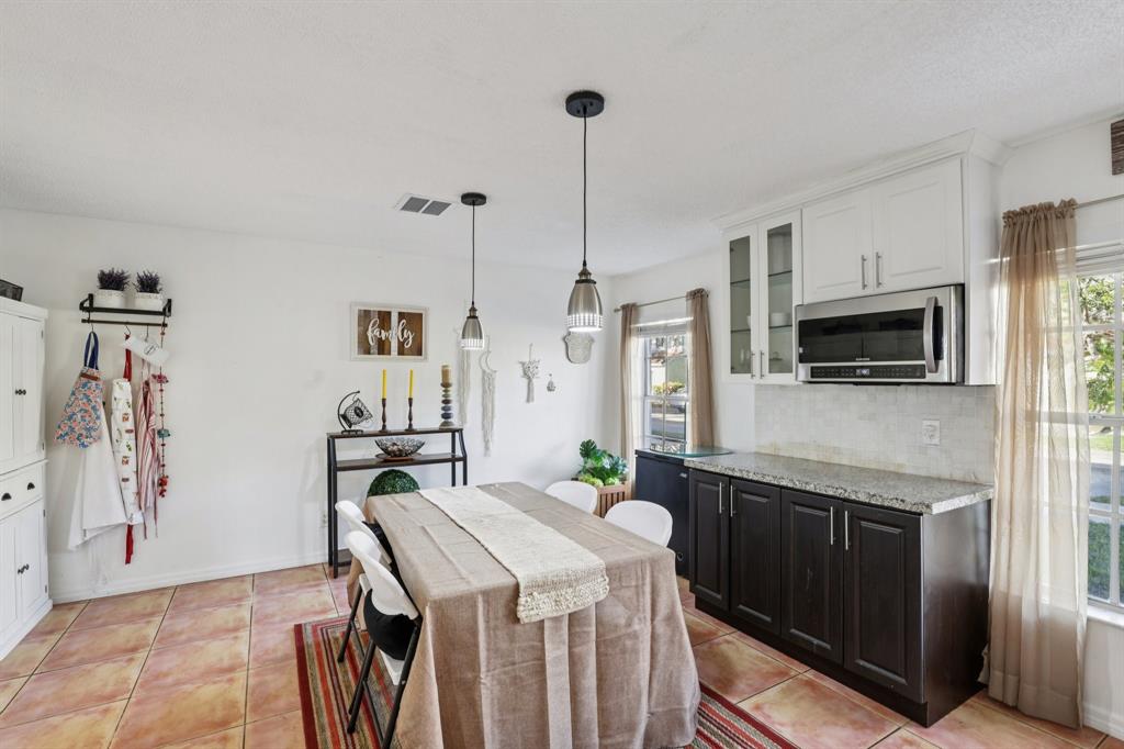 972 Azure Lane Weston, FL 33326 - Photo 19 of 61 The space comfortably accommodates a full dining set, making it suitable for both casual family meals and more formal occasions.