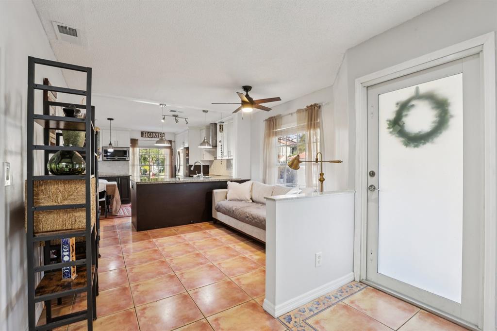 972 Azure Lane Weston, FL 33326 - Photo 20 of 61 a living room with stainless steel appliances furniture a chandelier and a view of kitchen