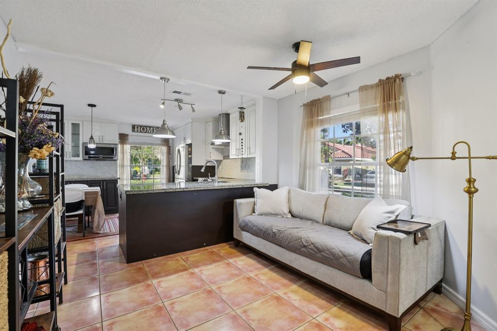 972 Azure Lane Weston, FL 33326 - Photo 21 of 61 a living room with furniture and a kitchen